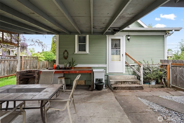 rear view of house featuring a patio, a fenced backyard, outdoor dining space, and entry steps