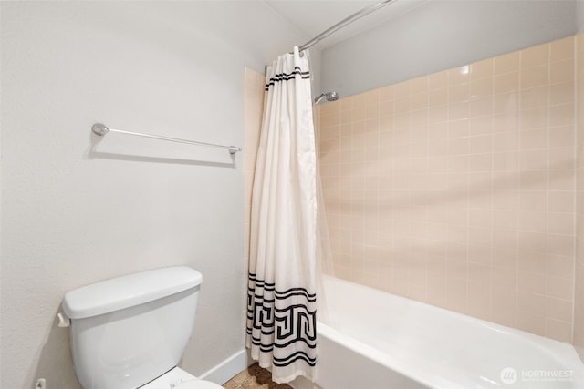 bathroom with toilet and shower / bathtub combination with curtain