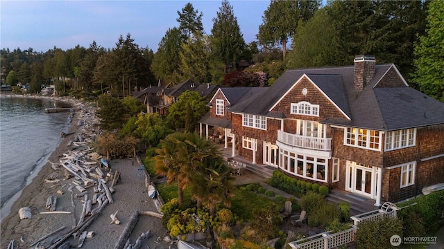 9325 Fauntleroy Way SW, Seattle, WA 98136 - exterior space featuring roof with shingles, a water view, a chimney, a balcony, and french doors