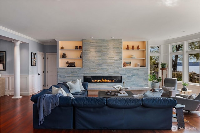 9325 Fauntleroy Way SW, Seattle, WA 98136 - living room with crown molding, decorative columns, wainscoting, wood finished floors, and a stone fireplace