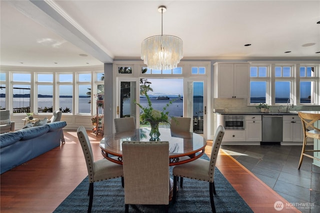 9325 Fauntleroy Way SW, Seattle, WA 98136 - dining space featuring a water view, a chandelier, and ornamental molding