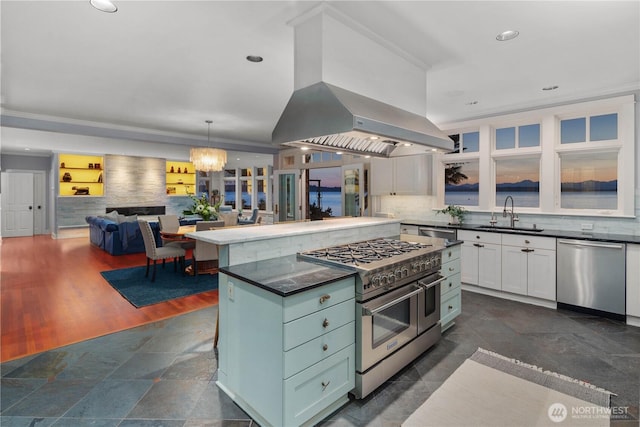 9325 Fauntleroy Way SW, Seattle, WA 98136 - kitchen with appliances with stainless steel finishes, dark countertops, tasteful backsplash, a sink, and white cabinets