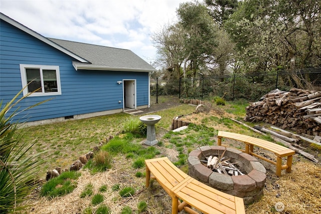 view of yard featuring fence and a fire pit