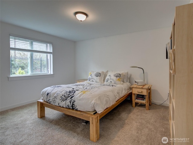 bedroom featuring baseboards and light carpet