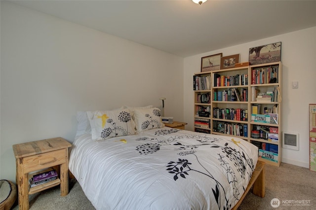 carpeted bedroom featuring visible vents and baseboards
