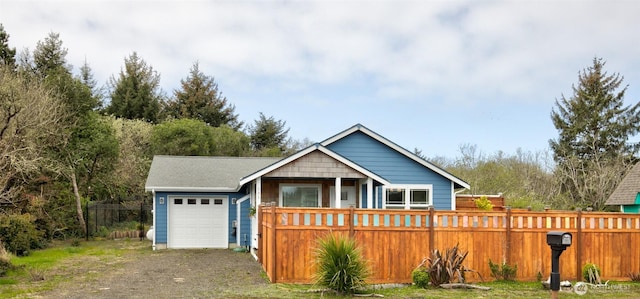 view of front of home featuring an attached garage, driveway, and fence private yard