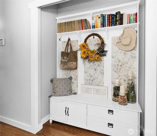 mudroom featuring dark wood finished floors and baseboards
