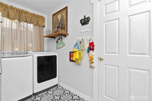 laundry room with tile patterned floors, washer and clothes dryer, laundry area, and baseboards