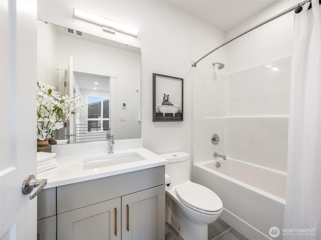 full bath with toilet, shower / bath combo, and vanity