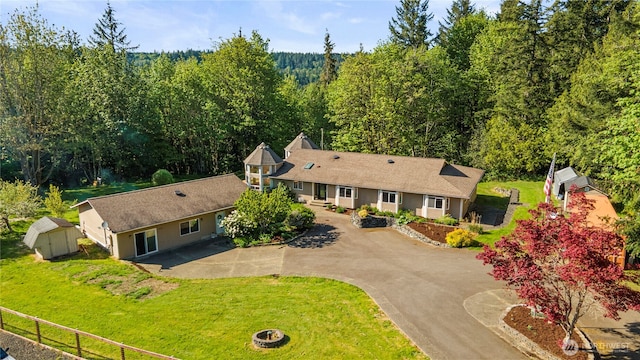 birds eye view of property with a view of trees