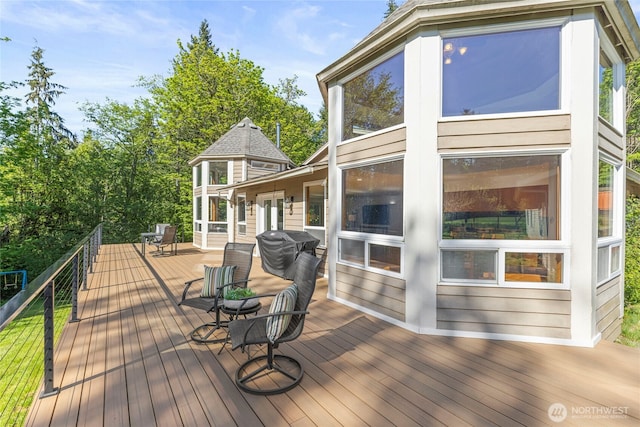 wooden deck with a sunroom