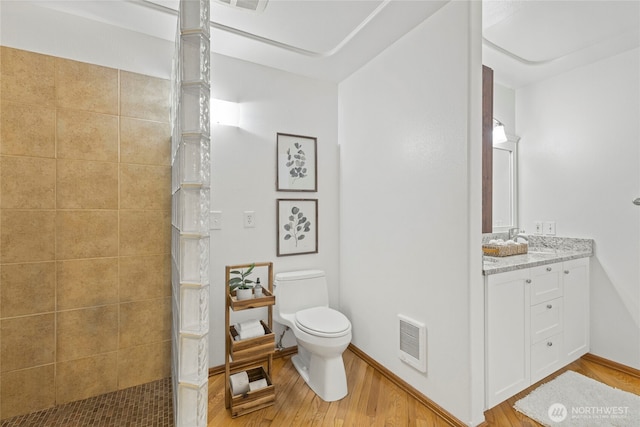 full bathroom with visible vents, wood finished floors, a walk in shower, vanity, and toilet