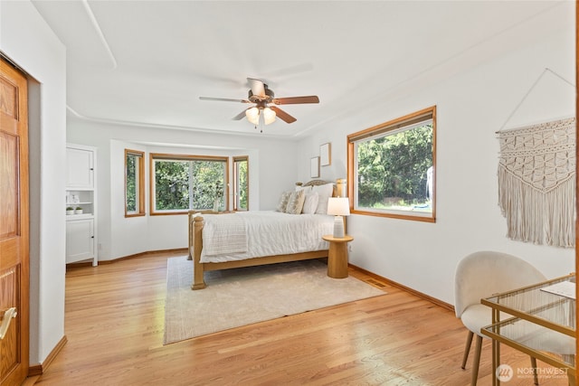 bedroom with multiple windows, light wood-style flooring, and visible vents