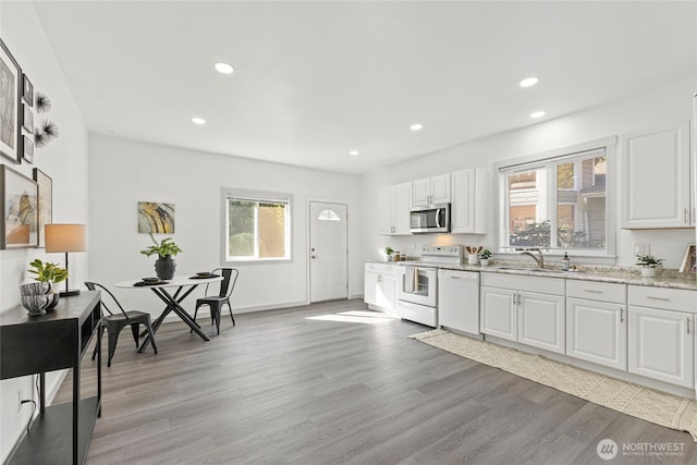 kitchen with white appliances, recessed lighting, and a wealth of natural light