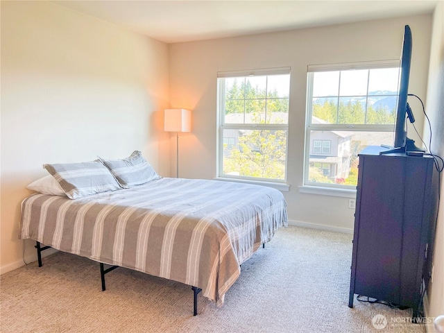 carpeted bedroom featuring baseboards