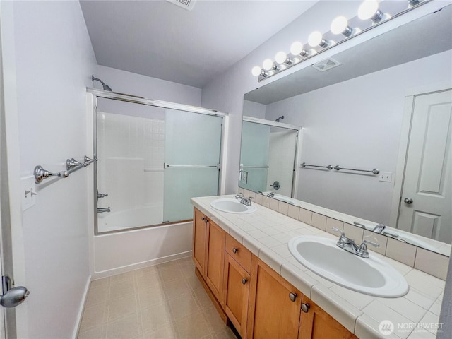 full bath with visible vents, a sink, tile patterned floors, and double vanity