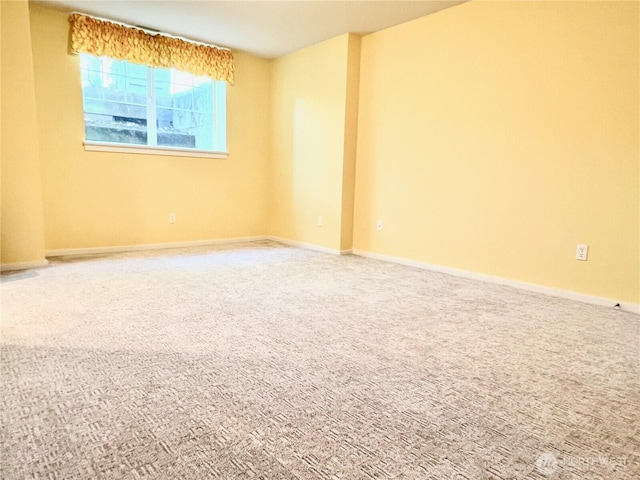 empty room with carpet floors and baseboards