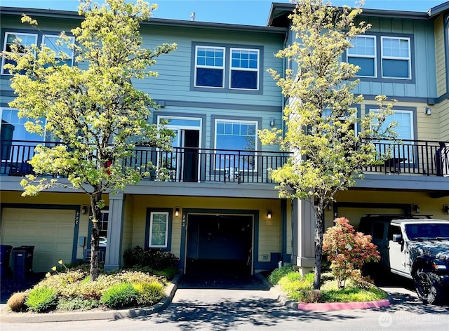 townhome / multi-family property with an attached garage and a balcony