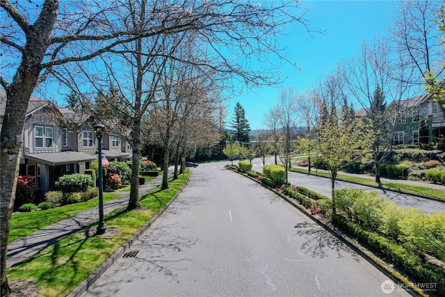view of road featuring a residential view, sidewalks, and curbs