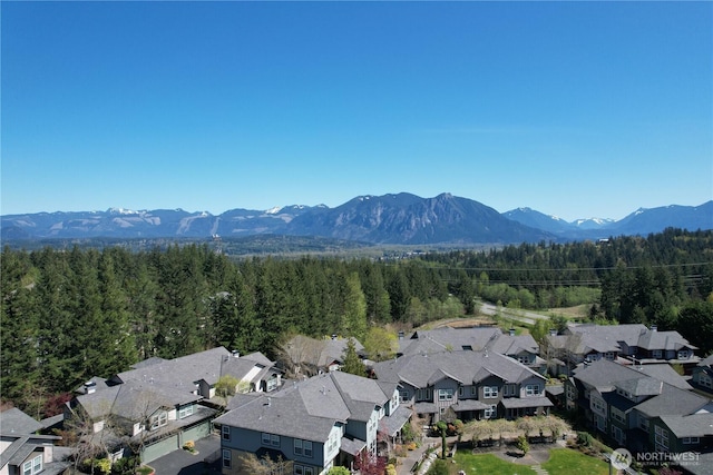 bird's eye view featuring a mountain view, a residential view, and a forest view