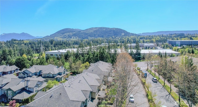 aerial view with a view of trees, a residential view, and a mountain view