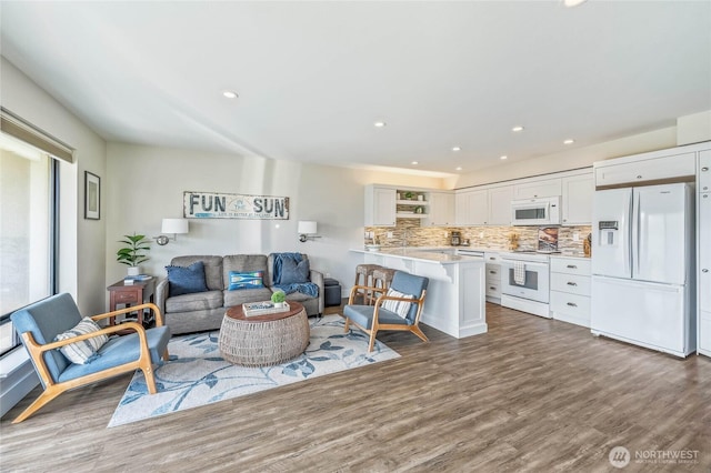 living room with recessed lighting and wood finished floors