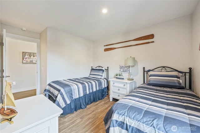 bedroom with baseboards and light wood-style floors