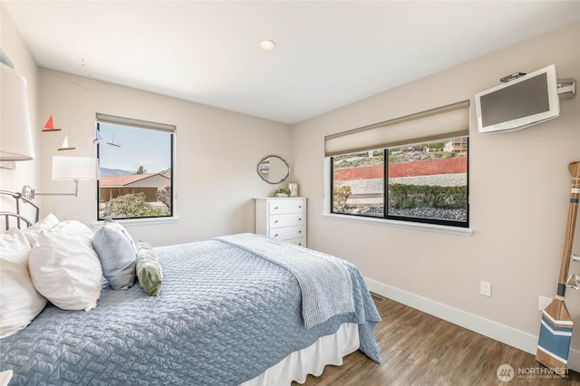 bedroom featuring wood finished floors and baseboards