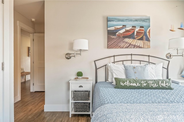 bedroom featuring baseboards and wood finished floors