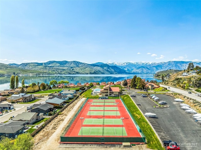 drone / aerial view featuring a water and mountain view