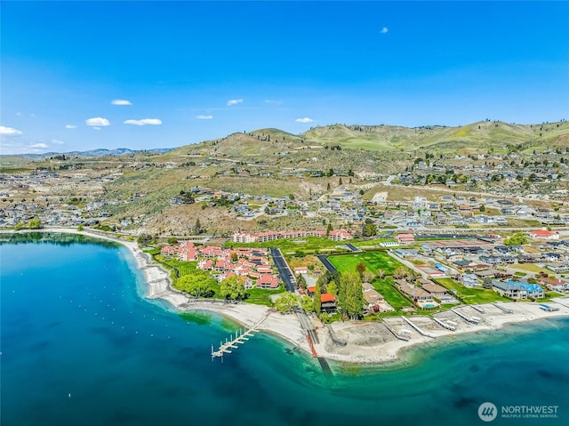 drone / aerial view featuring a water and mountain view and a residential view