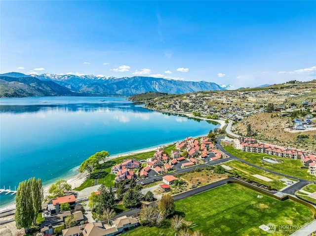 drone / aerial view featuring a water and mountain view