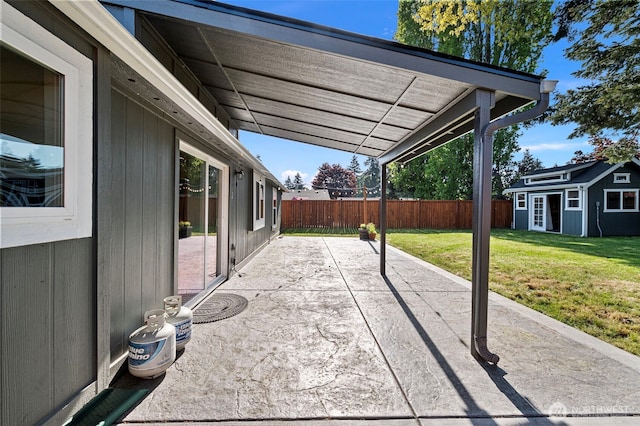view of patio featuring an outdoor structure and fence