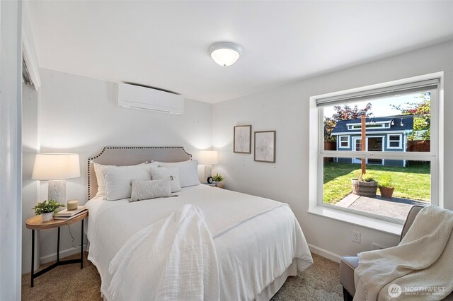 carpeted bedroom featuring baseboards, a wall mounted AC, and multiple windows