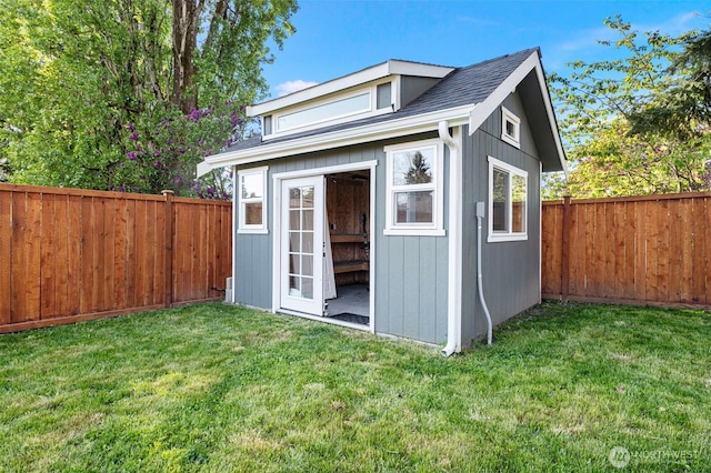 view of outdoor structure with a fenced backyard and an outdoor structure