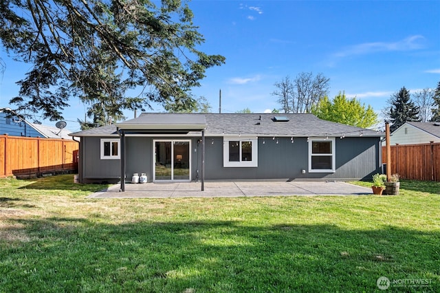 rear view of property featuring a patio, a fenced backyard, and a yard