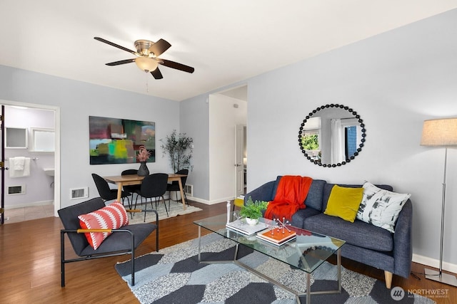 6357 37th Ave SW, Seattle, WA 98126 - living area featuring a ceiling fan, wood finished floors, and baseboards