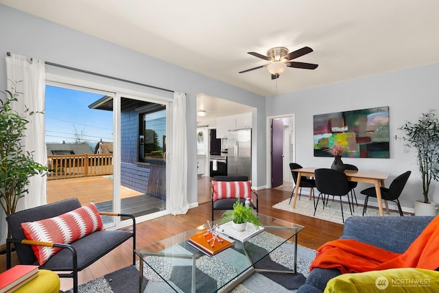 6357 37th Ave SW, Seattle, WA 98126 - living room featuring a ceiling fan, baseboards, and wood finished floors