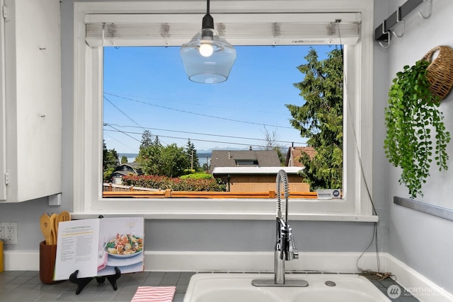 6357 37th Ave SW, Seattle, WA 98126 - kitchen view of a sink and white cabinets