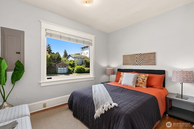 6357 37th Ave SW, Seattle, WA 98126 - bedroom with electric panel, wood finished floors, and baseboards