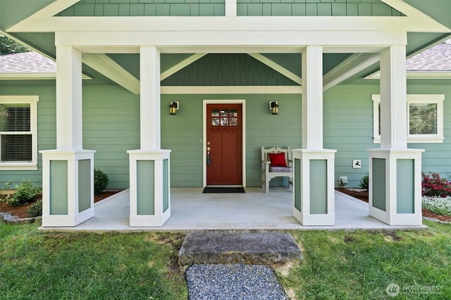 property entrance with a porch and roof with shingles