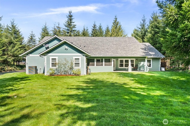 back of property with a lawn