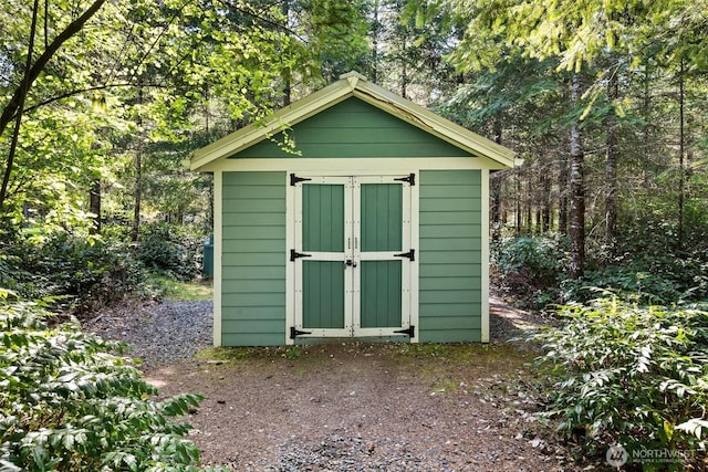 view of shed with a forest view