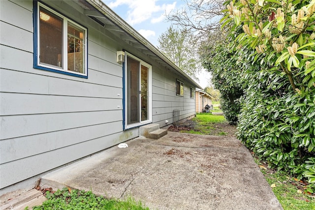 view of side of property with a patio area