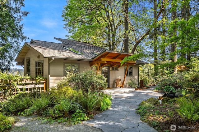 rustic home with a shingled roof