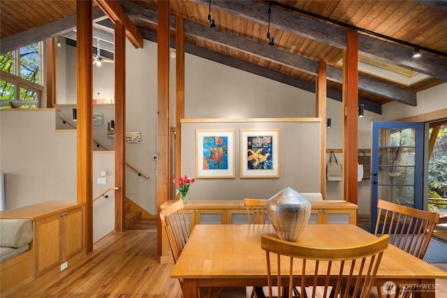 dining area featuring wooden ceiling, lofted ceiling with beams, stairs, and wood finished floors