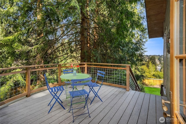 wooden deck featuring outdoor dining space