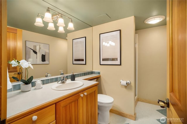 full bath with vanity, toilet, baseboards, walk in shower, and tile patterned floors