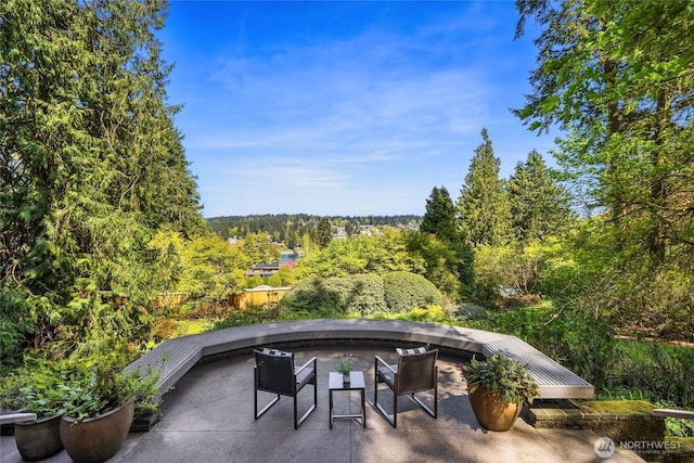 view of patio / terrace with a wooded view