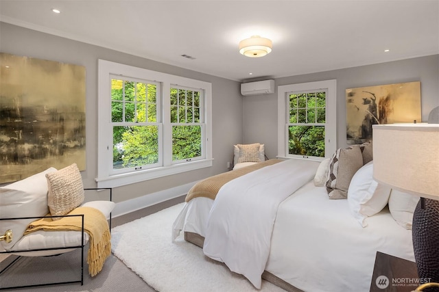 carpeted bedroom featuring baseboards, a wall mounted AC, recessed lighting, and visible vents
